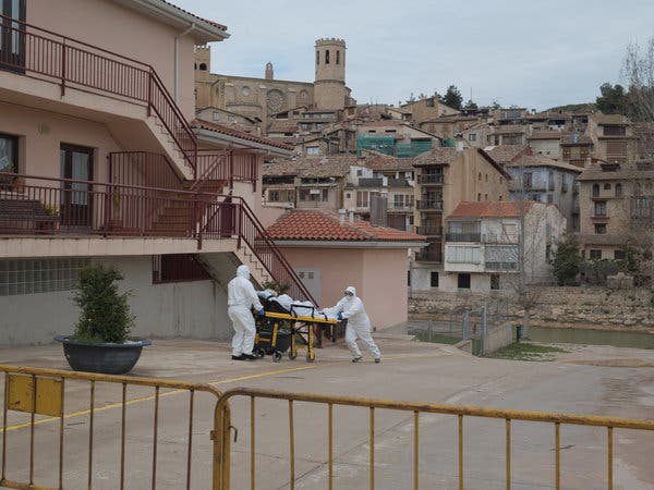 Medical workers evacuating a coronavirus patient from a nursing home in Valderrobres, Spain, this month. Nearly 50 of the 60 residents at the home tested positive for the pathogen.